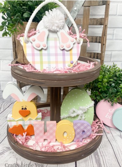 Unfinished kit measures apx. 6" tall on chick and 5" tall on basket, and includes: 
* 1 bunny in basket
* 2 bunny feet
* 1 chick with bunny ears
* 1 eggshell overlay
* 1 beak overlay
* 1 chick feet overlay
* 1 Egg
* 1 hop letters with "o" overlay
* Face and eyebrows vinyl