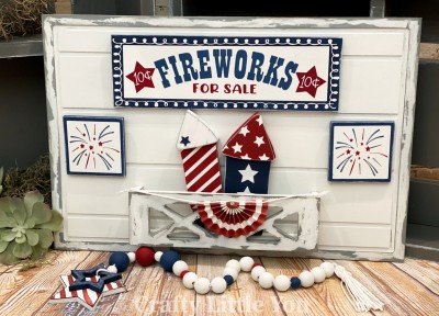 Unfinished kit measures apx. 11"x3.5" on sign and includes wooden MDF: 
* Main title plaque
* 2 side plaques
* 2 fireworks with top overlays
* Vinyl stencil & white stars
* 4 pieces Velcro