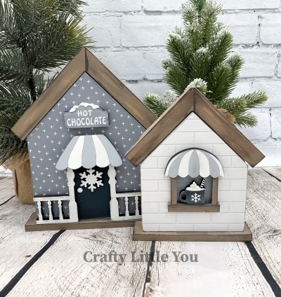 Unfinished kit measures apx. 8"x6.25" and includes wooden MDF: *2 house overlays *1 hot cocoa sign and white vinyl *1 window with mug and white vinyl *2 railings *1 snowflake *1 porch cover *2 pieces of velcro