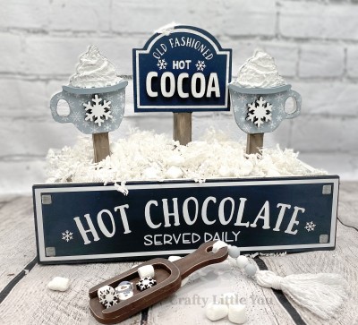 Unfinished kit measures apx. 10" tall on sing, and includes wooden MDF: *1 sign on stand with white vinyl *cocoa laser letters *2 hot cocoa mugs on stands *3 bases *2 mug rims *2 snowflakes
