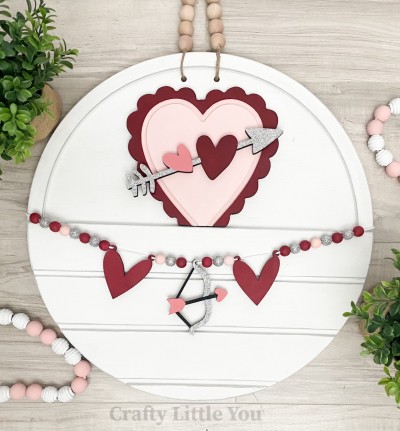 Unfinished kit measures apx. 7" and includes wooden MDF: 
* 1 scalloped heart with groove
* 1 heart and arrow overlay
* 2 hanging hearts for banner
* 1 Cupid's arrow for banner
* 2 pieces Velcro