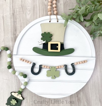 Unfinished kit measures apx. 6.5" tall and includes wooden MDF: 
* 1 hat main piece with grooves
* 1 buckle overlay
* 1 shamrock tag with overlay letters
* 2 hanging horseshoes
* 1 hanging shamrock
* 2 pieces Velcro