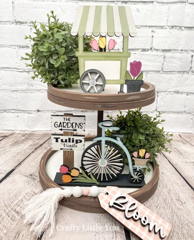 Unfinished kit measures apx. 6" tall on the flower cart, and includes wooden MDF: 
* 1 tulip flower cart with wheel overlay
* 1 potted tulip
* 1 garden and tulip sign with wood engravings
* 1 bike with attached tulip basket
* 1 tulip bouquet
* 1 base
* Black vinyl