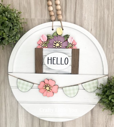 Unfinished kit measures apx. 7.25" tall and includes wooden MDF: 
* 1 flower basket with attached flowers and leaves
* 2 flower center overlays
* 1 oval overlay
* 1 flower banner piece
* 3 half-circle banner pieces
* Black vinyl
* 2 pieces Velcro 