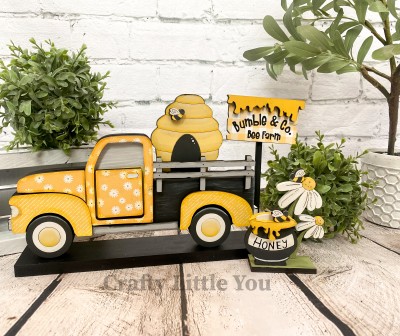 Unfinished kit includes wooden MDF:
* 1 beehive with engraved lines
* 1 pot with dripping honey overlay
* 2 flowers
* 1 base
* 3 bee overlays
* 1 sign with dripping honey overlay
* 1 dowel
* Black vinyl