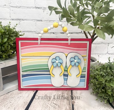Unfinished kit measures apx. 8.5"x12" and includes wooden MDF: 
* 1 rectangle plaque with grooves 
* 2 flip flop overlays
* 2 flip flop strap overlays 
* 2 flower overlays