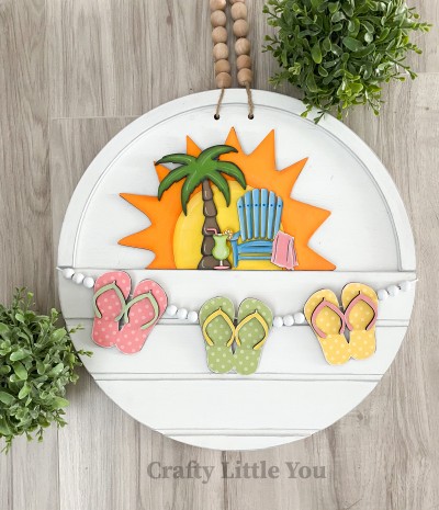Unfinished kit measures apx. 6.5" tall on the sun and includes wooden MDF:
*1 sun
*1 palm tree
*1 beach chair with attached towel
*1 lemonade cup
*3 flip flops
*3 flip flop toe pieces
*2 pieces Velcro