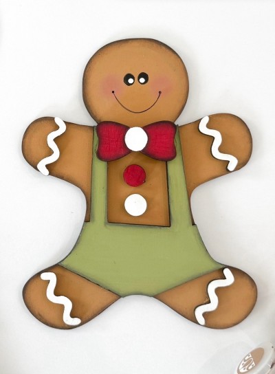 Unfinished kit measures apx. 6.5" and includes wooden MDF:
*1 gingerbread cookie main piece
*1 bow tie
*1 pair of shorts 
*2 buttons
*4 icing squiggle overlays
*Black vinyl