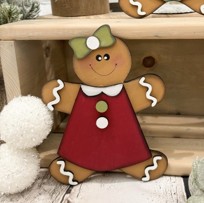 Unfinished kit measures apx. 6.5" and includes wooden MDF:
*1 gingerbread cookie main piece
*1 hair bow
*1 dress 
*1 collar
*4 icing squiggle overlays
*Black vinyl