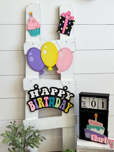 Unfinished kit measures apx. 8.75" tall on the balloons, and includes wooden MDF:
*3 connected balloons
*1 set of “Happy Birthday” wood letters with backing
*1 cupcake
*Sprinkle overlays
*1 present