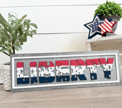 Unfinished kit measures apx. 6"x18" and includes wooden MDF:
*1 main piece board
*1 frame overlay
*1 set of “Liberty” wood letter overlays