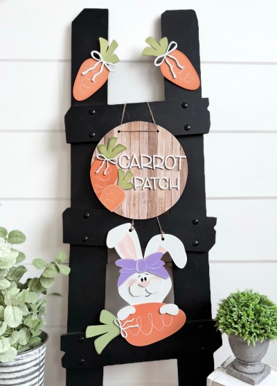 Unfinished kit measures 12" tall on bunny and includes wooden MDF:*1 bunny with carrot
*1 set of bunny overlays (ear, bow, nose, hands, bow) *1 circle *1 “CARROT PATCH” wood lasered letters *2 Carrots for circle *3 bows *2 carrot *1 black vinyl face