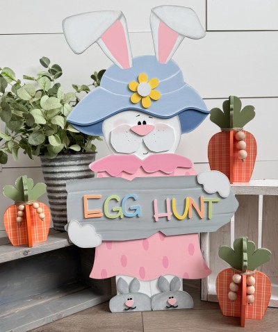 Unfinished kit measures 26"and includes wooden MDF: *1 bunny body main piece *1 bunny skirt and slippers main piece *1 flower and hat brim overlay *2 slipper overlays with face overlays *1 collar and nose overlay *1 sign with 2 hand overlays *1 set of “EGG HUNT” wood lasered letters *1 black vinyl face